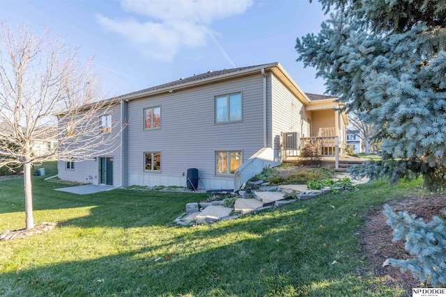 rear view of house with a lawn and a deck