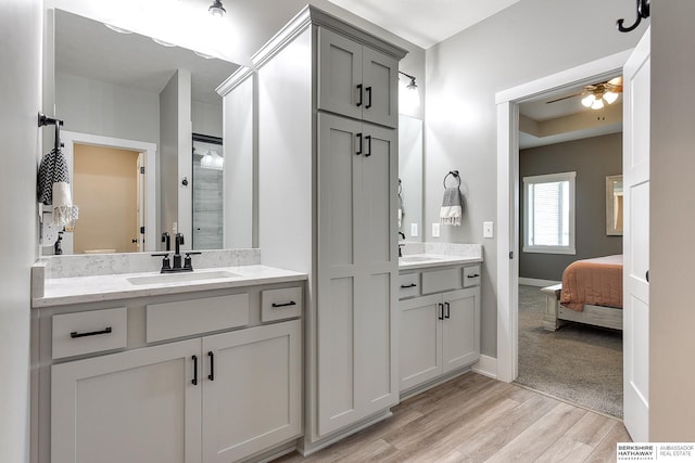 bathroom with ceiling fan, hardwood / wood-style floors, and vanity