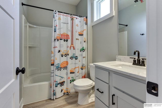 full bathroom featuring hardwood / wood-style flooring, vanity, toilet, and shower / bath combo with shower curtain