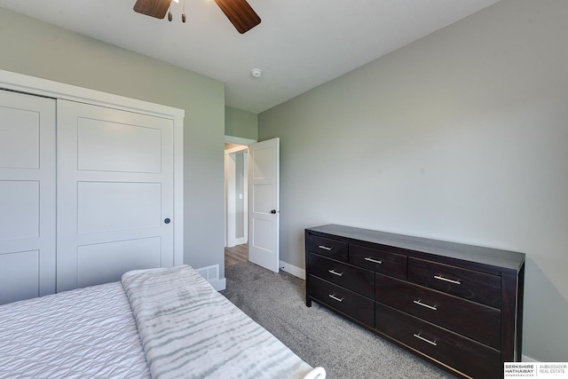 carpeted bedroom featuring ceiling fan and a closet