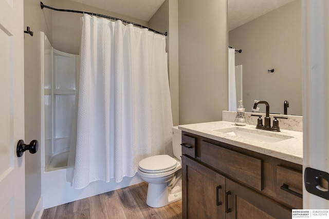 full bathroom featuring vanity, toilet, shower / bathtub combination with curtain, a textured ceiling, and wood-type flooring