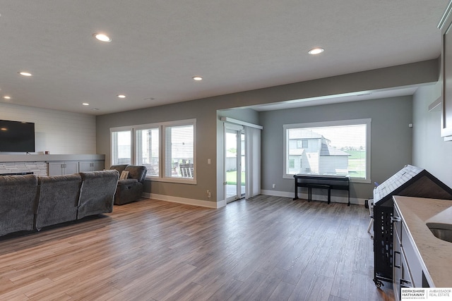 living room featuring light hardwood / wood-style floors and a textured ceiling