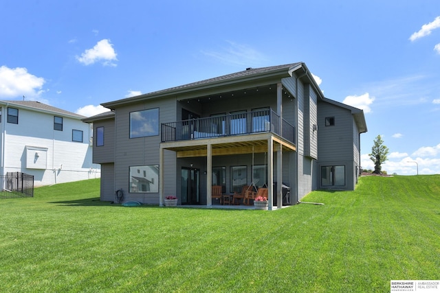 back of property featuring a lawn and a balcony