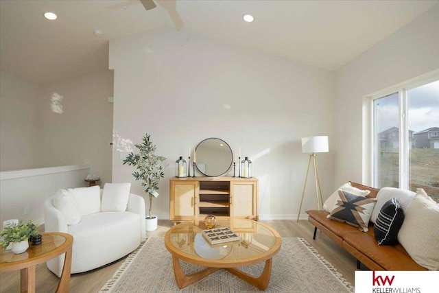 living room with lofted ceiling and light wood-type flooring