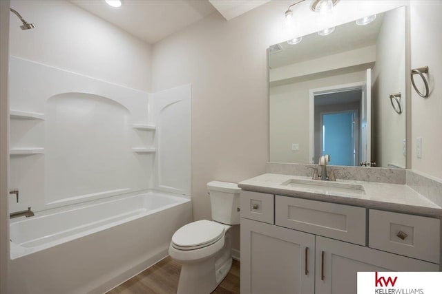 full bathroom featuring hardwood / wood-style floors, vanity, toilet, and shower / bath combination