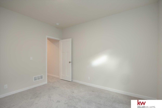 unfurnished room with light carpet