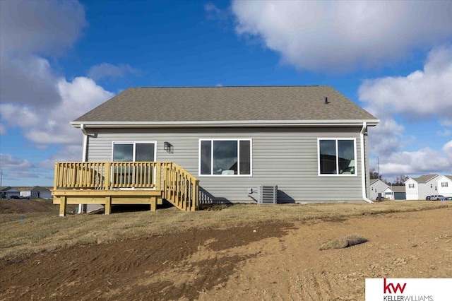 rear view of house featuring central AC unit and a deck