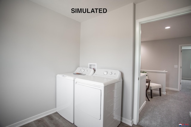 clothes washing area with dark hardwood / wood-style floors and washing machine and clothes dryer