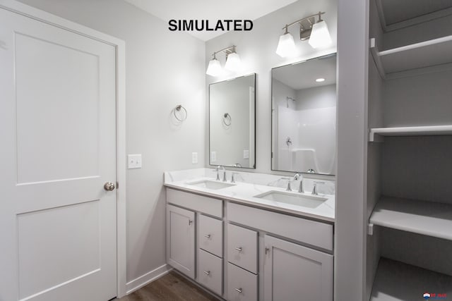 bathroom with hardwood / wood-style floors, vanity, and walk in shower