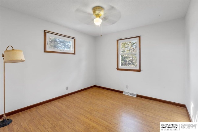 spare room featuring light hardwood / wood-style floors and ceiling fan