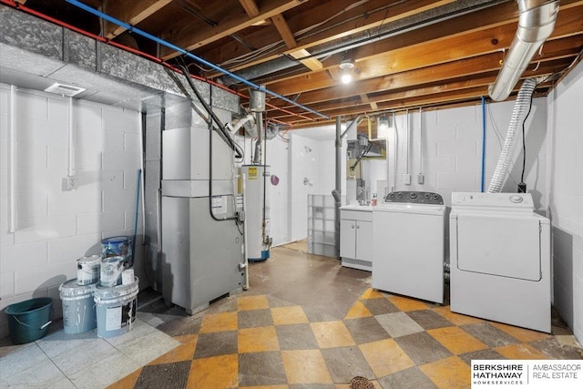 basement with washing machine and dryer and gas water heater