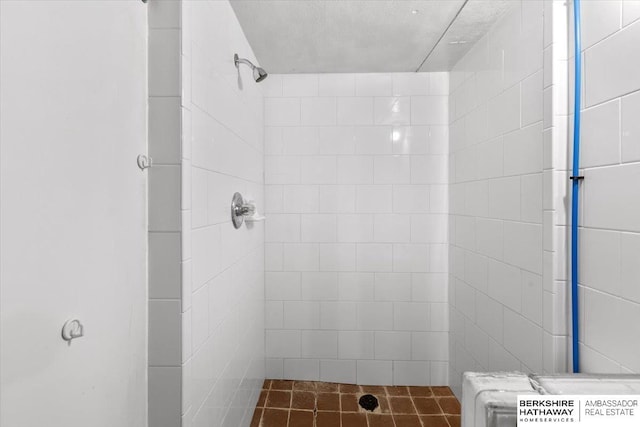 bathroom with tiled shower