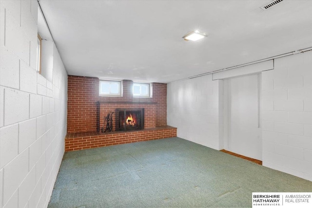 unfurnished living room featuring carpet and a brick fireplace