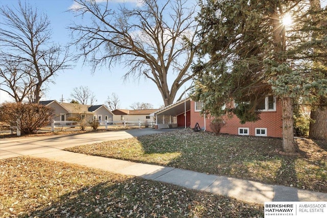 view of front of house with a carport and a front yard