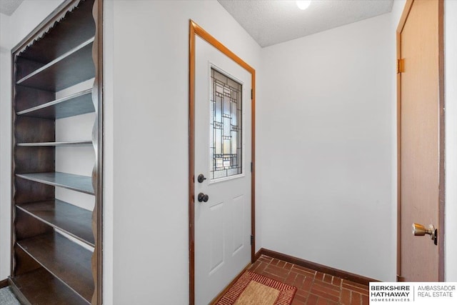 entryway with a textured ceiling