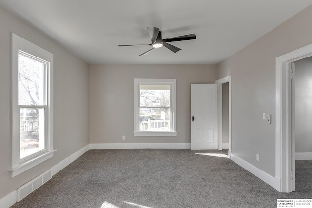 spare room with ceiling fan, carpet, and a healthy amount of sunlight