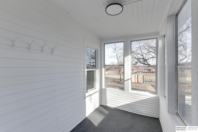 unfurnished sunroom featuring wooden ceiling