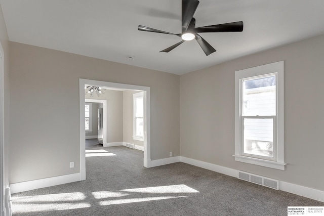 spare room featuring light carpet and ceiling fan