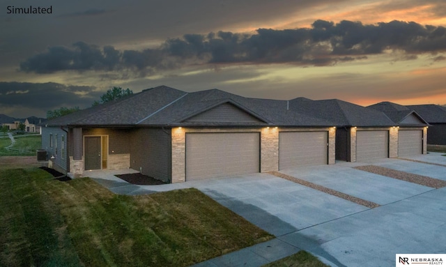 prairie-style home featuring a lawn and a garage