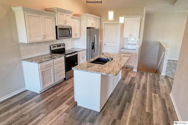 kitchen featuring appliances with stainless steel finishes, backsplash, lofted ceiling, and sink