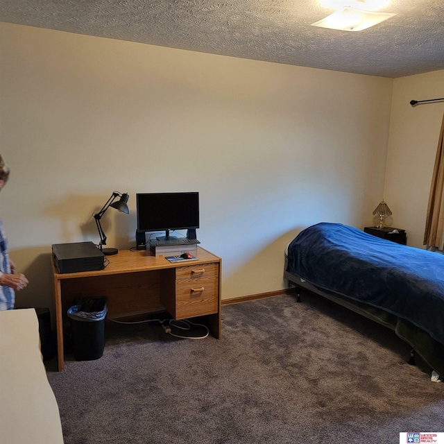 carpeted bedroom featuring a textured ceiling