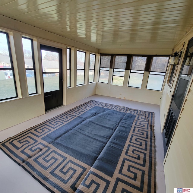 unfurnished sunroom with wood ceiling