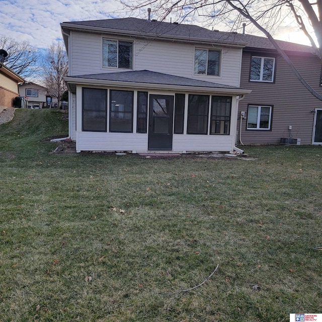 back of house featuring a sunroom and a yard