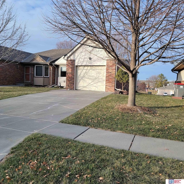 ranch-style home featuring a garage and a front lawn