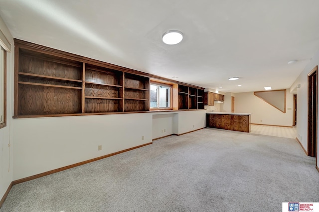 unfurnished living room featuring light carpet