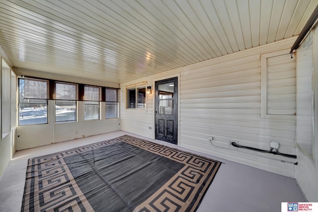 unfurnished sunroom with wood ceiling