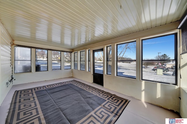 unfurnished sunroom with wooden ceiling