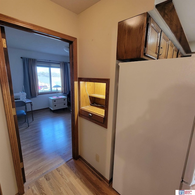 hall with light hardwood / wood-style flooring