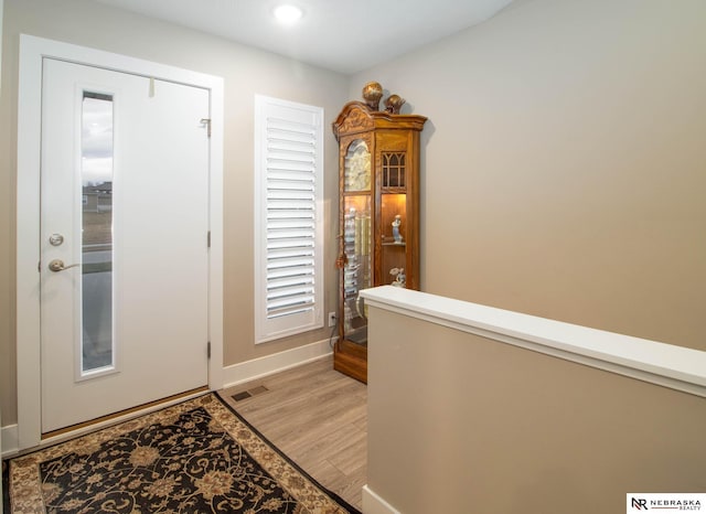 foyer entrance with light hardwood / wood-style floors