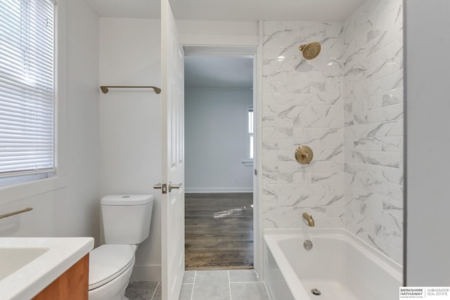 full bathroom featuring tiled shower / bath, toilet, vanity, and hardwood / wood-style flooring