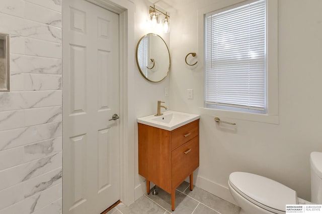 bathroom with tile patterned floors, vanity, and toilet