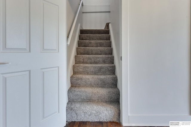 staircase with hardwood / wood-style flooring