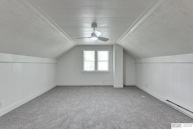 additional living space featuring carpet, ceiling fan, lofted ceiling, and a baseboard radiator