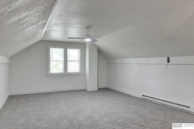 bonus room with a textured ceiling, light carpet, lofted ceiling, and a baseboard heating unit