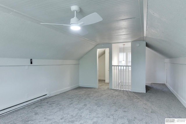 bonus room featuring carpet, vaulted ceiling, ceiling fan, and a baseboard heating unit