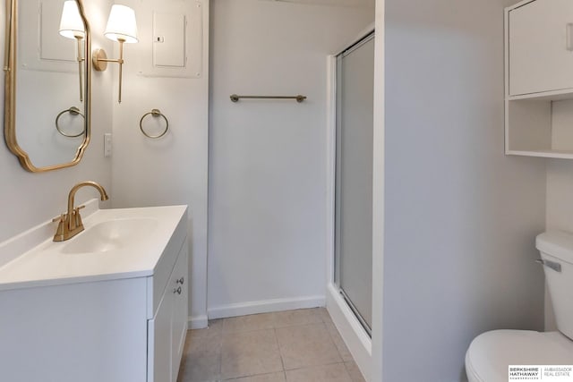 bathroom with tile patterned flooring, vanity, toilet, and a shower with shower door