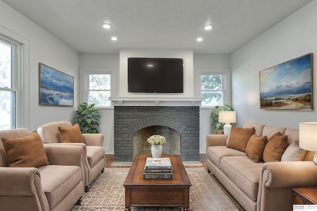 living room with a brick fireplace and a wealth of natural light