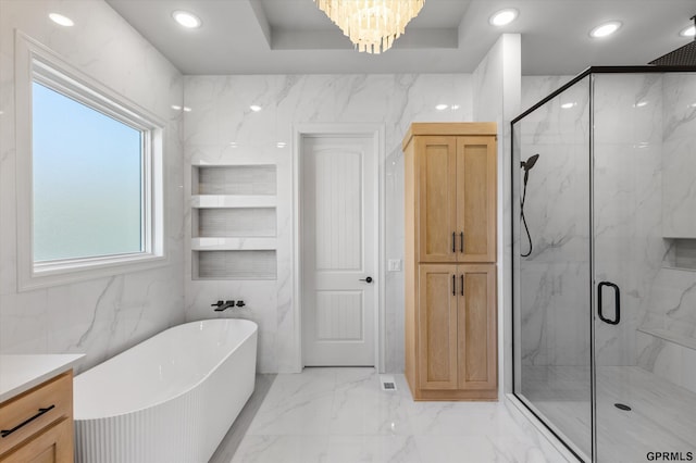 bathroom with independent shower and bath, tile walls, and a notable chandelier