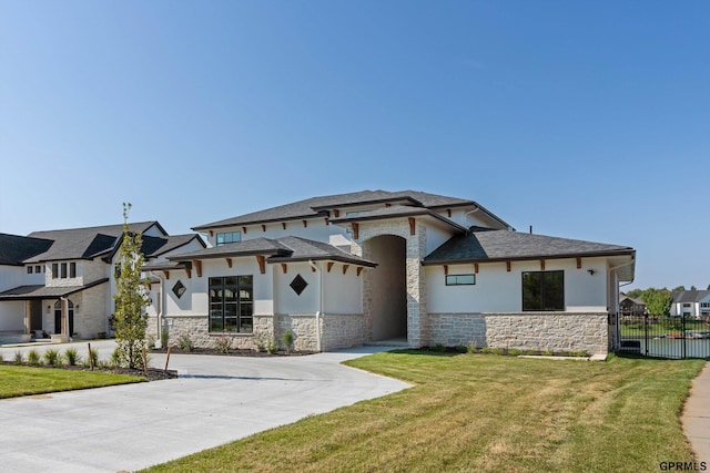 prairie-style home featuring a front lawn