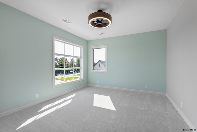 unfurnished room with light colored carpet