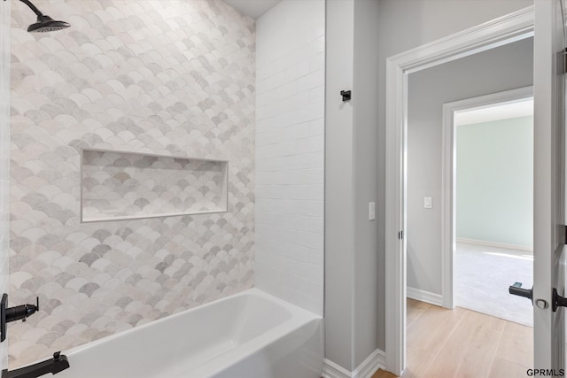 bathroom featuring hardwood / wood-style floors and tiled shower / bath combo