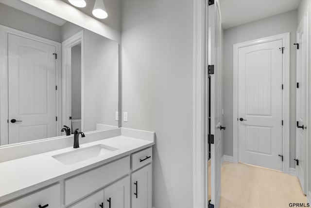 bathroom with hardwood / wood-style floors and vanity