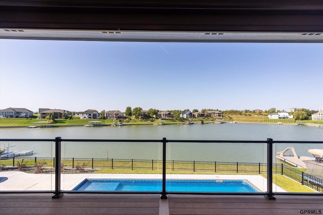 view of swimming pool with a water view