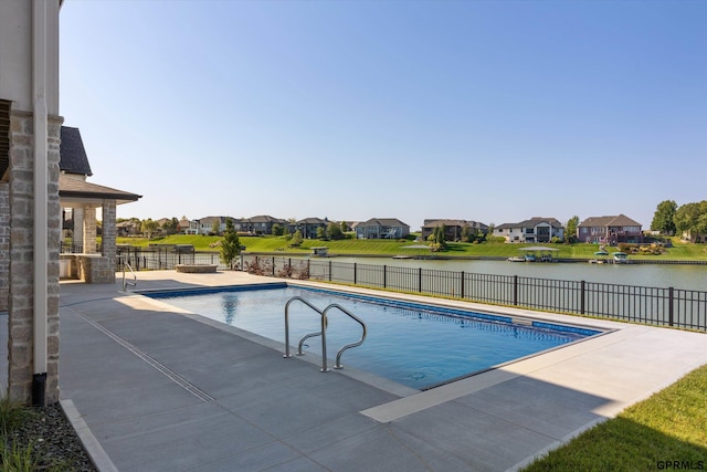 view of swimming pool featuring a water view and a patio area