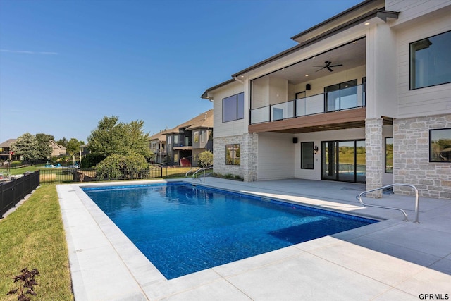 view of swimming pool featuring ceiling fan and a patio