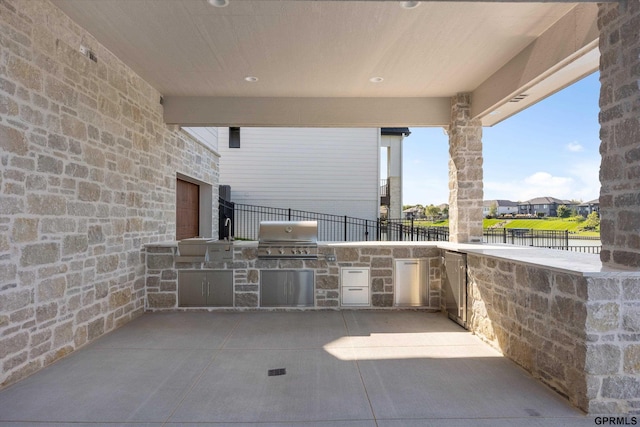 view of patio featuring a grill and an outdoor kitchen